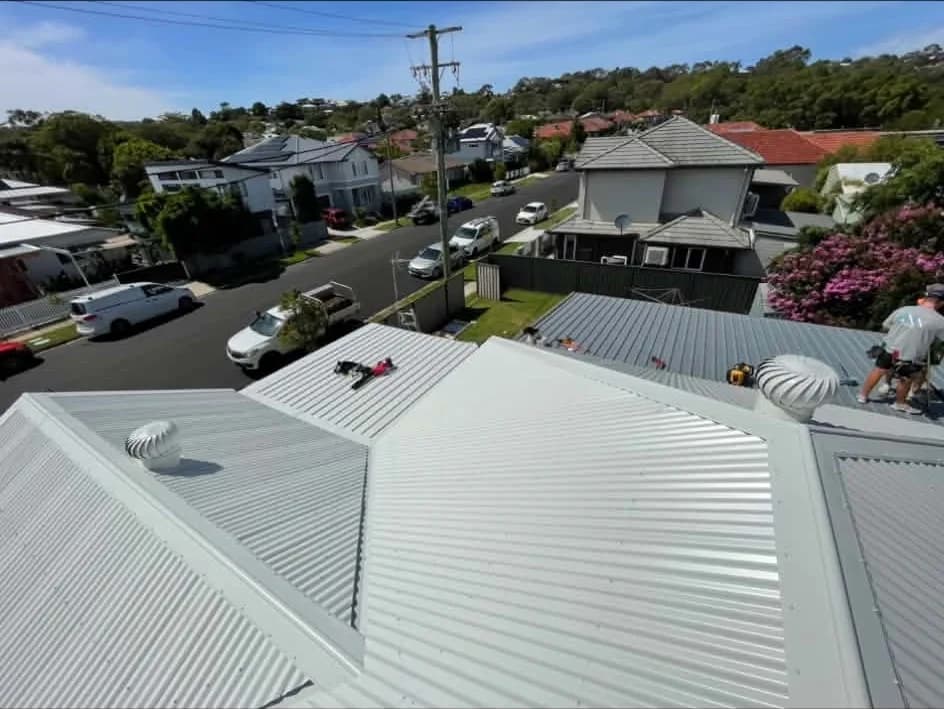 New Colorbond roof with whirlybirds above a suburban street